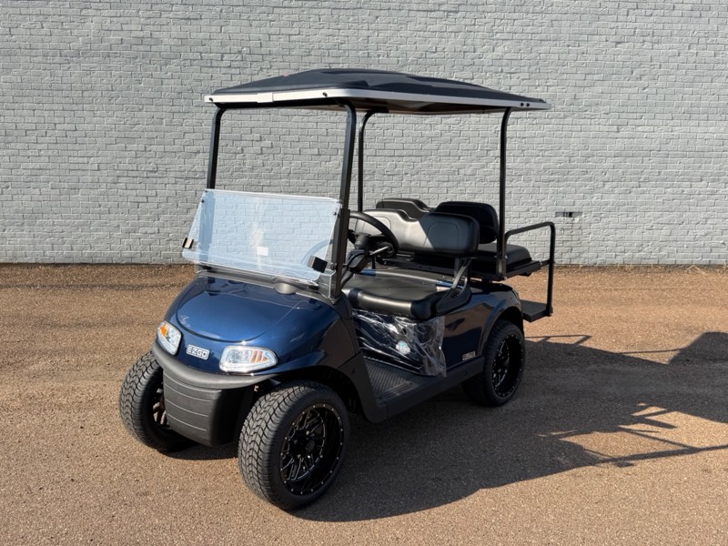 Certified pre-owned 2026 E-Z-GO RXV Elite in deep blue with rear flip seat and black wheels, for sale at Jane's Golf Carts in Pearl, MS
